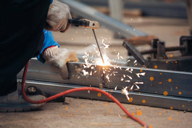 Welding process with sparks on steel frame